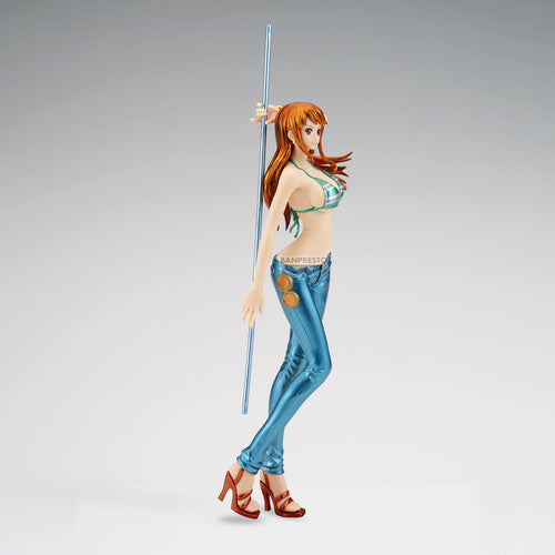 Figurine of a character with red hair and blue pants holding a staff on a gray background